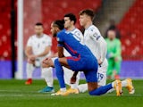 England's Dominic Calvert-Lewin takes a knee on March 25, 2021