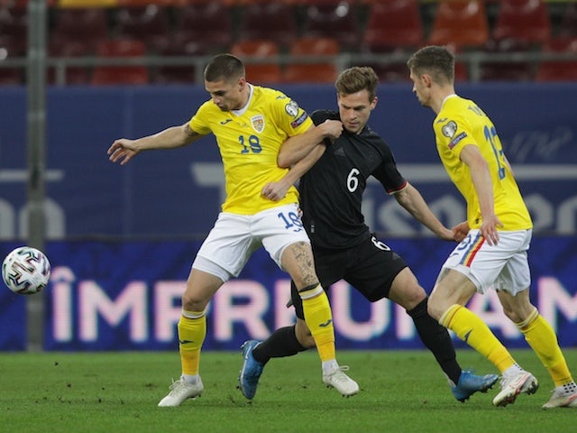 Germany's Joshua Kimmich in action with Romania's Razvan Marin on March 28, 2021