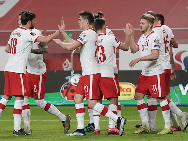 Poland's Robert Lewandowski celebrates scoring their first goal with teammates on March 28, 2021