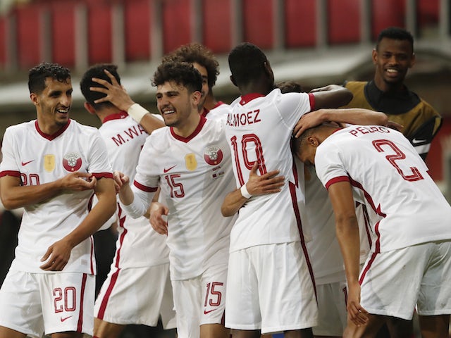 Qatar's Hassan Al Haydos celebrates scoring their second goal with teammates on March 27, 2021