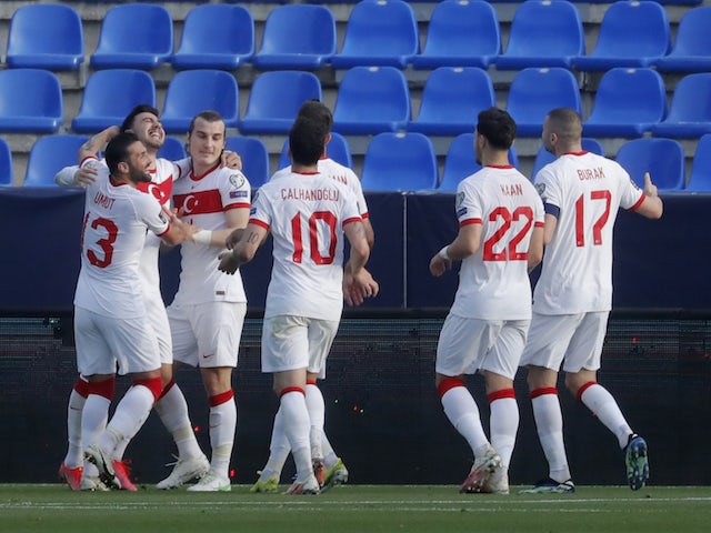 Turkey's Caglar Soyuncu celebrates scoring their second goal with teammates on March 27, 2021