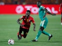 Uganda's Allan Kyambadde in action with Senegal's Sadio Mane in July 2019