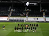Fulham and Wolverhampton Wanderers players observe a period of silence following Prince Philip's death on April 9, 2021