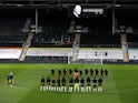 Fulham and Wolverhampton Wanderers players observe a period of silence following Prince Philip's death on April 9, 2021