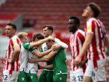 Millwall's Murray Wallace celebrates with teammates after scoring their first goal against Stoke City in the Championship on April 5, 2021