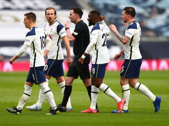 Tottenham Hotspur players surround the referee against Manchester United in the Premier League on April 11, 2021