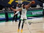 Boston Celtics guard Marcus Smart grabs a rebound away from Denver Nuggets center Nikola Jokic on April 11, 2021