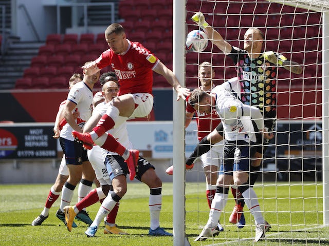 Bristol City's Daniel Bentley in action with Luton Town's Ryan Tunnicliffe in the Championship on April 25, 2021