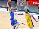 Dallas Mavericks center Kristaps Porzingis dunks past Los Angeles Lakers forward Anthony Davis on April 23, 2021