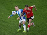 Huddersfield Town's Lewis O'Brien in action with Barnsley's Dominik Frieser in the Championship on April 21, 2021