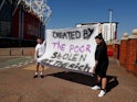 Manchester United fans hold an anti Super League banner outside Old Trafford as twelve of Europe's top football clubs launch a breakaway Super League