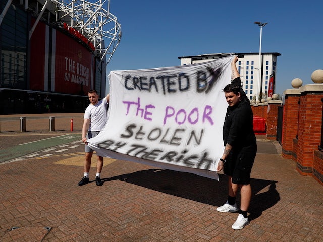 Manchester United fans hold an anti Super League banner outside Old Trafford as twelve of Europe's top football clubs launch a breakaway Super League