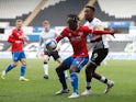 Swansea's Jamal Lowe in action with Queens Park Rangers' Osman Kakay in the Championship on April 20, 2021