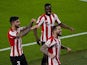 Athletic Bilbao's Inigo Martinez celebrates scoring their second goal with teammates on April 25, 2021