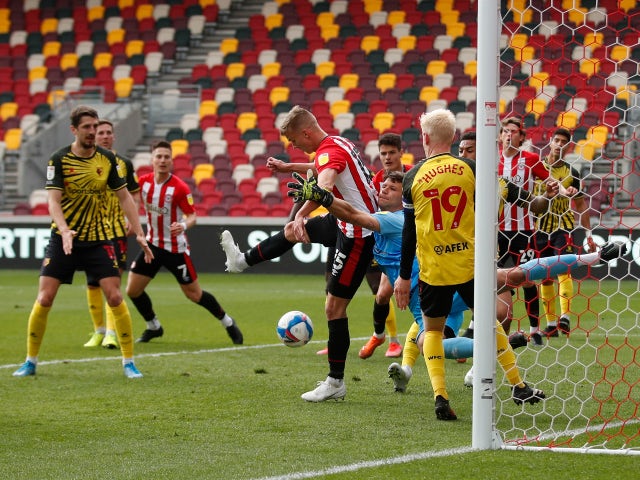 Brentford's Marcus Forss in action with Watford goalkeeper Daniel Bachmann in the Championship on May 1, 2021