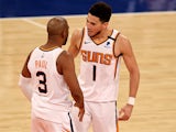 Chris Paul of the Phoenix Suns celebrates his three point shot with teammate Devin Booker on April 27, 2021