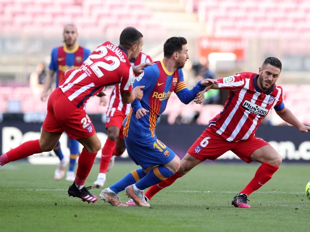 FC Barcelona's Lionel Messi in action with Atletico Madrid's Koke in La Liga on May 8, 2021