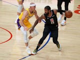 LA Clippers guard Paul George handles the ball while defended by Los Angeles Lakers guard Alex Caruso on May 7, 2021