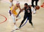 LA Clippers guard Paul George handles the ball while defended by Los Angeles Lakers guard Alex Caruso on May 7, 2021
