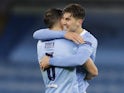 Manchester City's Ruben Dias and John Stones celebrate after the match on May 4, 2021