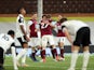 Fulham players look dejected as Burnley's Ashley Westwood celebrates scoring their first goal  in the Premier League on May 10, 2021