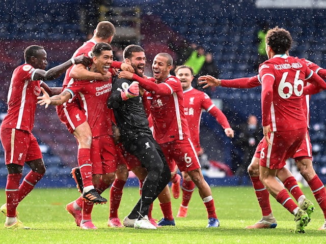Liverpool's Alisson celebrates scoring their second goal with teammates on May 16, 2021