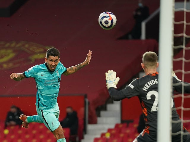 Liverpool's Roberto Firmino scores against Manchester United in the Premier League on May 13, 2021