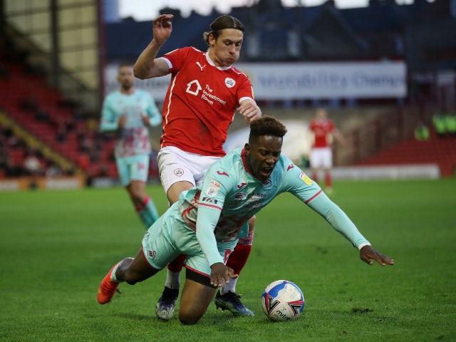 Barnsley's Callum Brittain in action with Swansea City's Jamal Lowe in the Championship playoffs on May 17, 2021