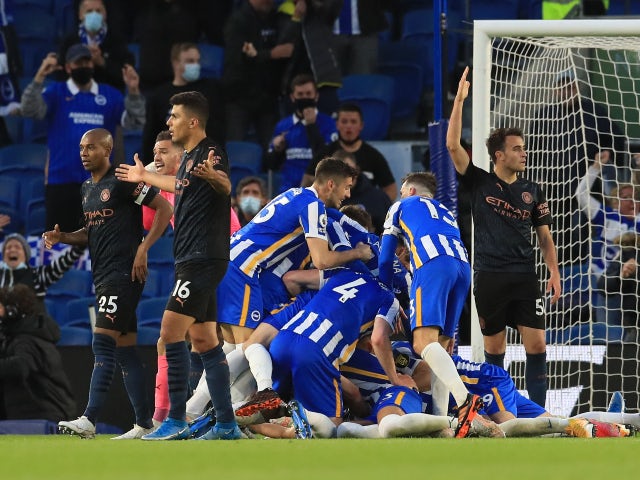 Brighton & Hove Albion's Dan Burn celebrates scoring their third goal against Manchester City in the Premier League on May 18, 2021
