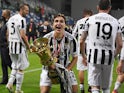 Juventus' Federico Chiesa celebrates with the Coppa Italia trophy on May 19, 2021