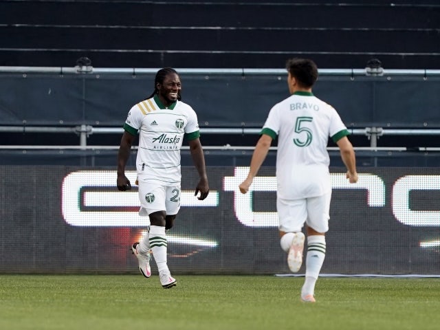 Portland Timbers forward Yimmi Chara celebrates with defender Claudio Bravo after scoring a goal on 15 May, 2021