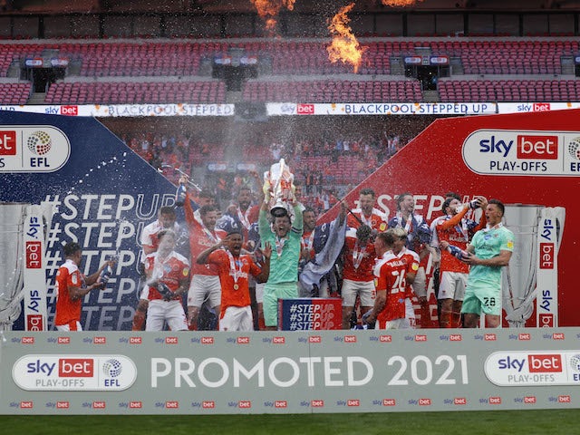 Blackpool players celebrate winning the League One playoff final on May 30, 2021