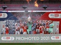 Blackpool players celebrate winning the League One playoff final on May 30, 2021