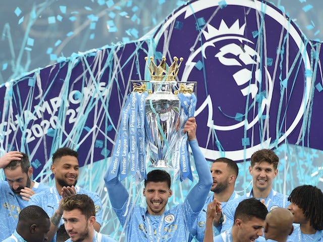 Manchester City's Ruben Dias celebrates with the trophy after winning the Premier League on May 23, 2021
