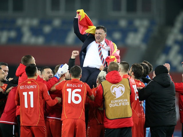 North Macedonia coach Igor Angelovski celebrates with players after qualifying for Euro 2020 in November 2020
