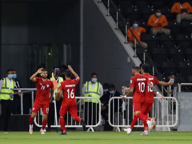 Afghanistan's Omid Popalzay celebrates scoring their first goal with teammates on June 11, 2021