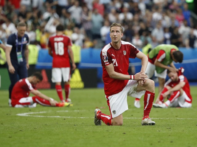 Austria players look dejected after being knocked out of Euro 2016