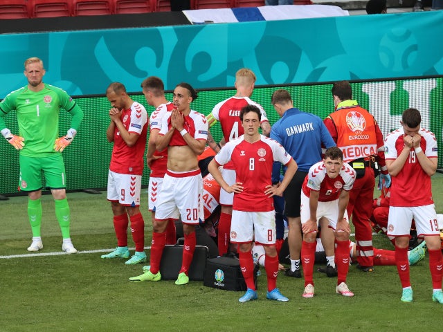 Denmark's Thomas Delaney, Andreas Christensen and teammates stand in front of Christian Eriksen as he receives medical attention at Euro 2020 on June 12, 2021