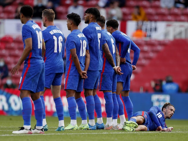 England's Jack Grealish lays down behind the wall to defend a free kick on June 6, 2021