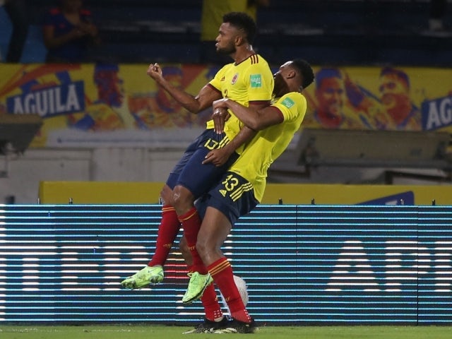 Colombia's Miguel Borja celebrates scoring their second goal with teammate Yerry Mina on June 9, 2021