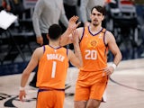 Phoenix Suns forward Dario Saric reacts with guard Devin Booker against the Denver Nuggets on June 12, 2021