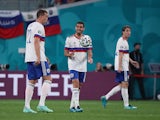 Russia's Artem Dzyuba and Magomed Ozdoyev looks dejected after Belgium's Romelu Lukaku scores their first goal on June 12, 2021