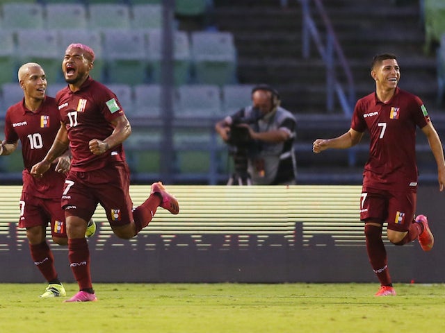 Venezuela's Josef Martínez celebrates scoring their first goal with Romulo Otero and Jefferson Savarino later disallowed after a VAR review on June 8, 2021