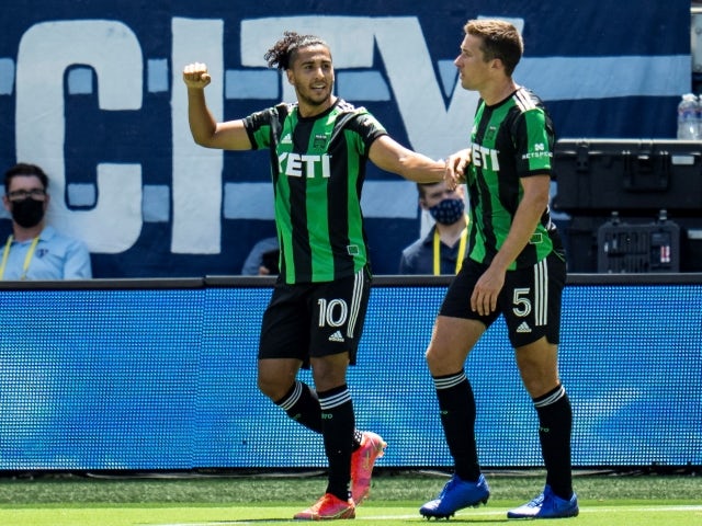 Austin FC forward Cecilio Dominguez celebrates with defender Matt Besler after scoring a goal on June 12, 2021