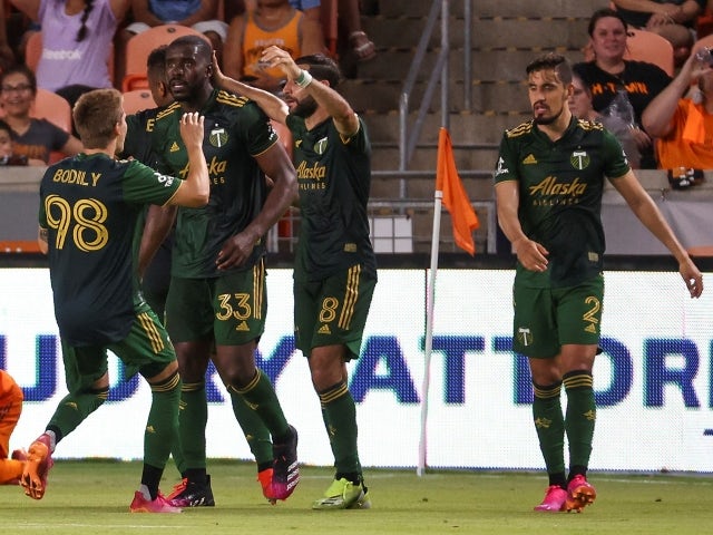 Portland Timbers forward Jeremy Ebobisse celebrates with teammates after scoring a goal during stoppage time on June 24, 2021