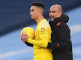 Manchester City manager Pep Guardiola and Fulham's Antonee Robinson pictured in December 2020