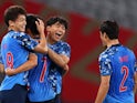 Takefusa Kubo of Japan celebrates scoring their first goal with teammates on July 22, 2021