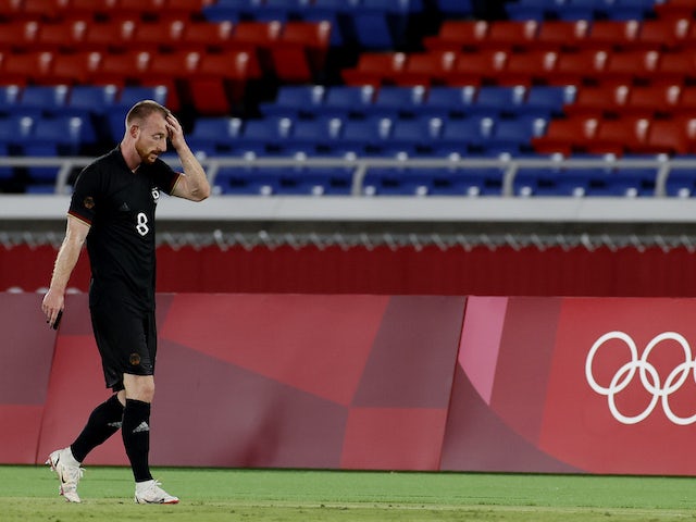 Maximilian Arnold of Germany walks off the pitch after being shown a red card by referee Ivan Barton on July 22, 2021