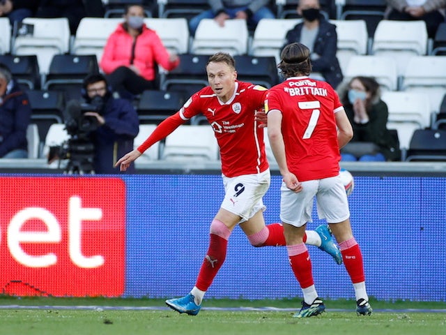 Barnsley's Cauley Woodrow celebrates scoring their first goal with Callum Brittain in May 2021