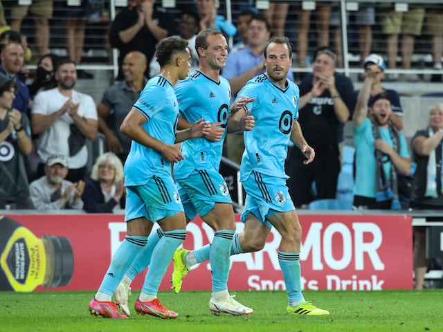 Minnesota United midfielder Hassani Dotson (31) and defender Chase Gasper (77) celebrate a goal after a goal by defender Brent Kallman (14) against the Houston Dynamo in the second half at Allianz Field on August 7, 2021